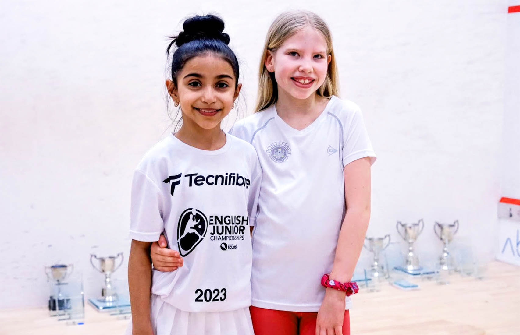 Two girls on a squash court at the 2023 English Junior Championships